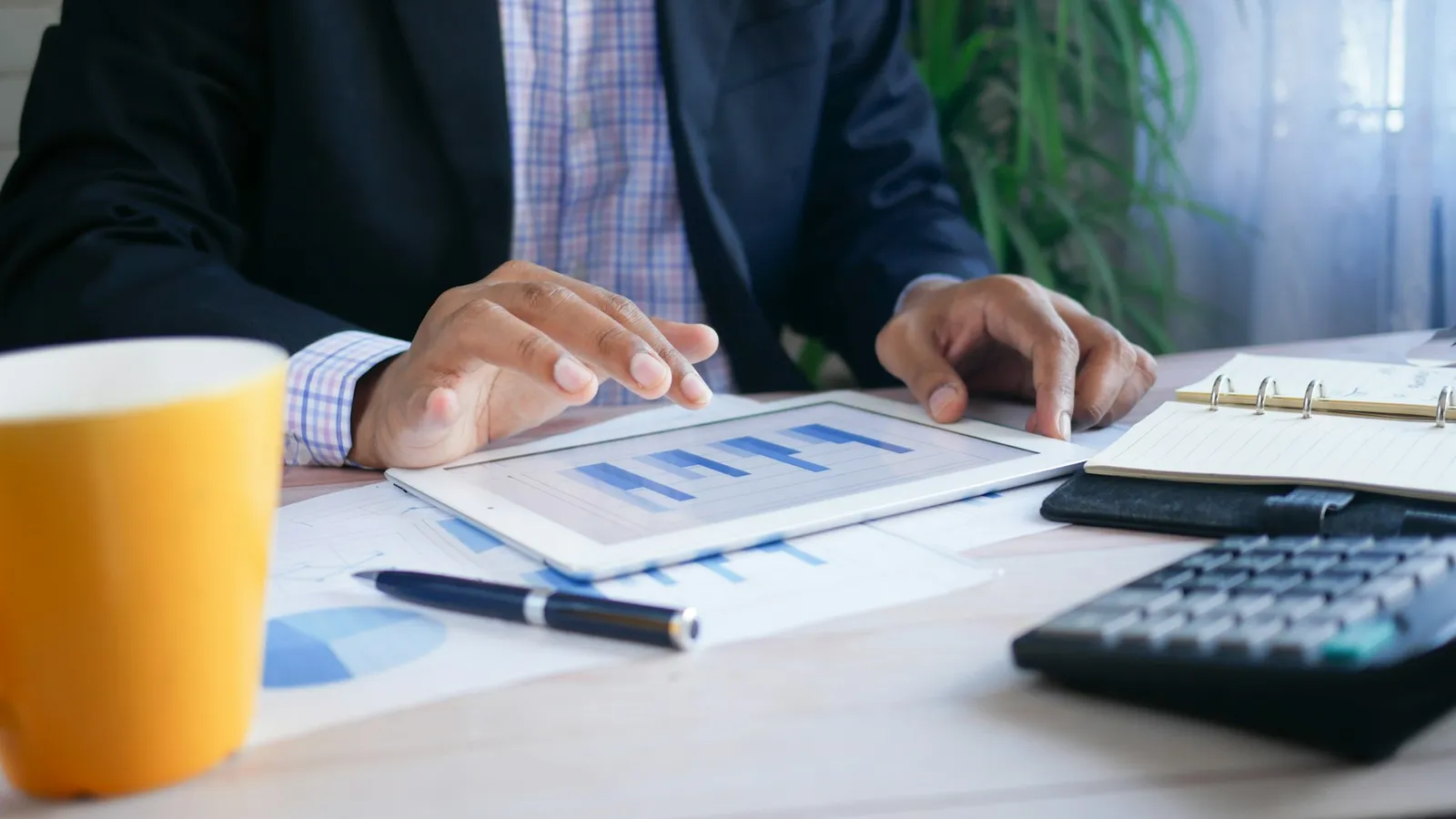 A finance manager reviewing figures on a tablet