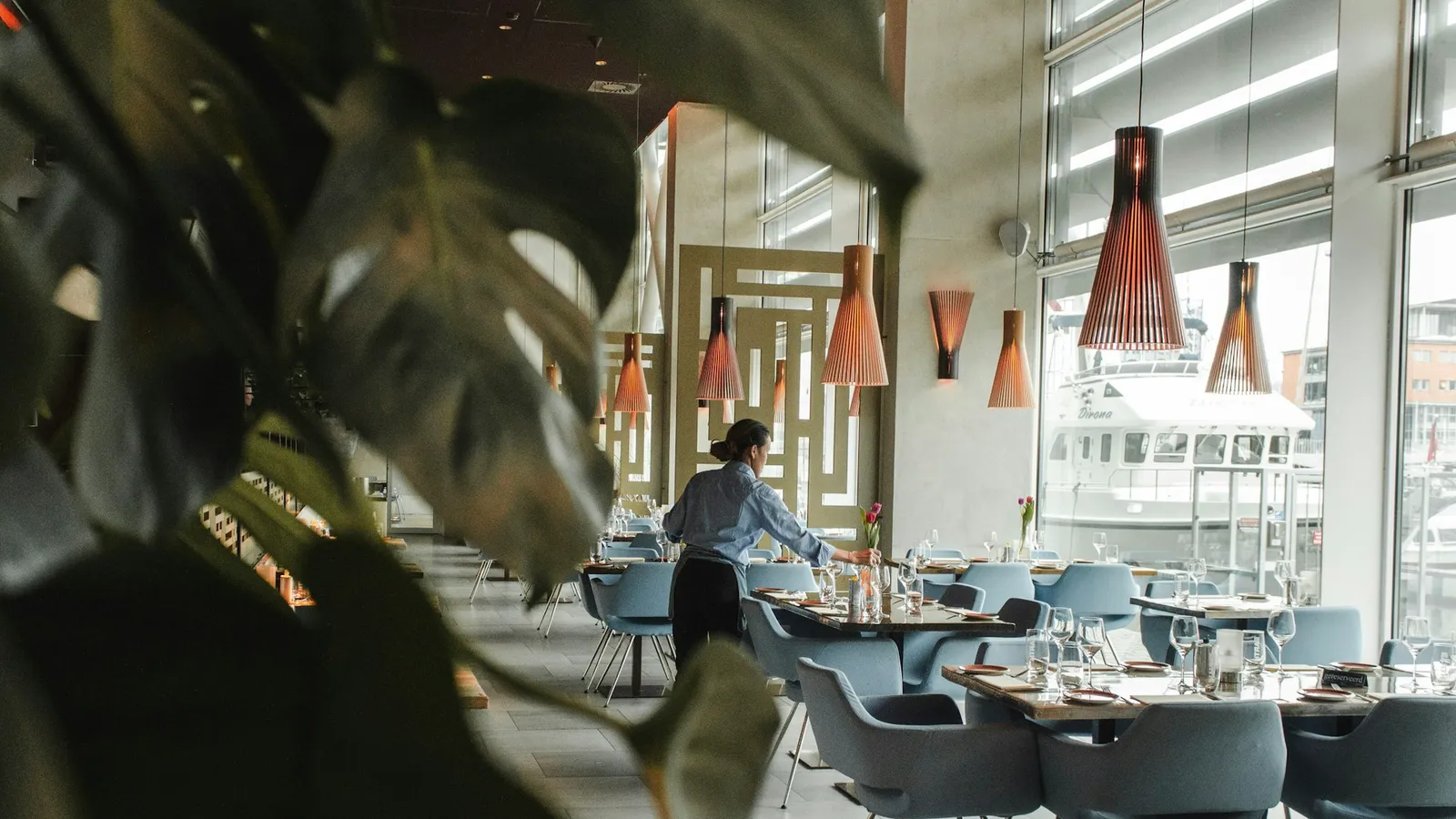 A restaurant dining room being set before service